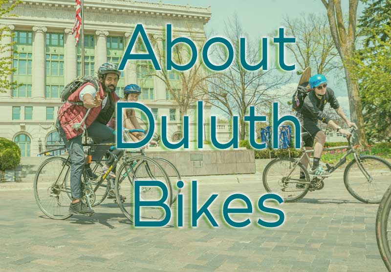 "About Duluth Bikes" text over pickture of three cyclists in Duluth Civic Center cobblestones